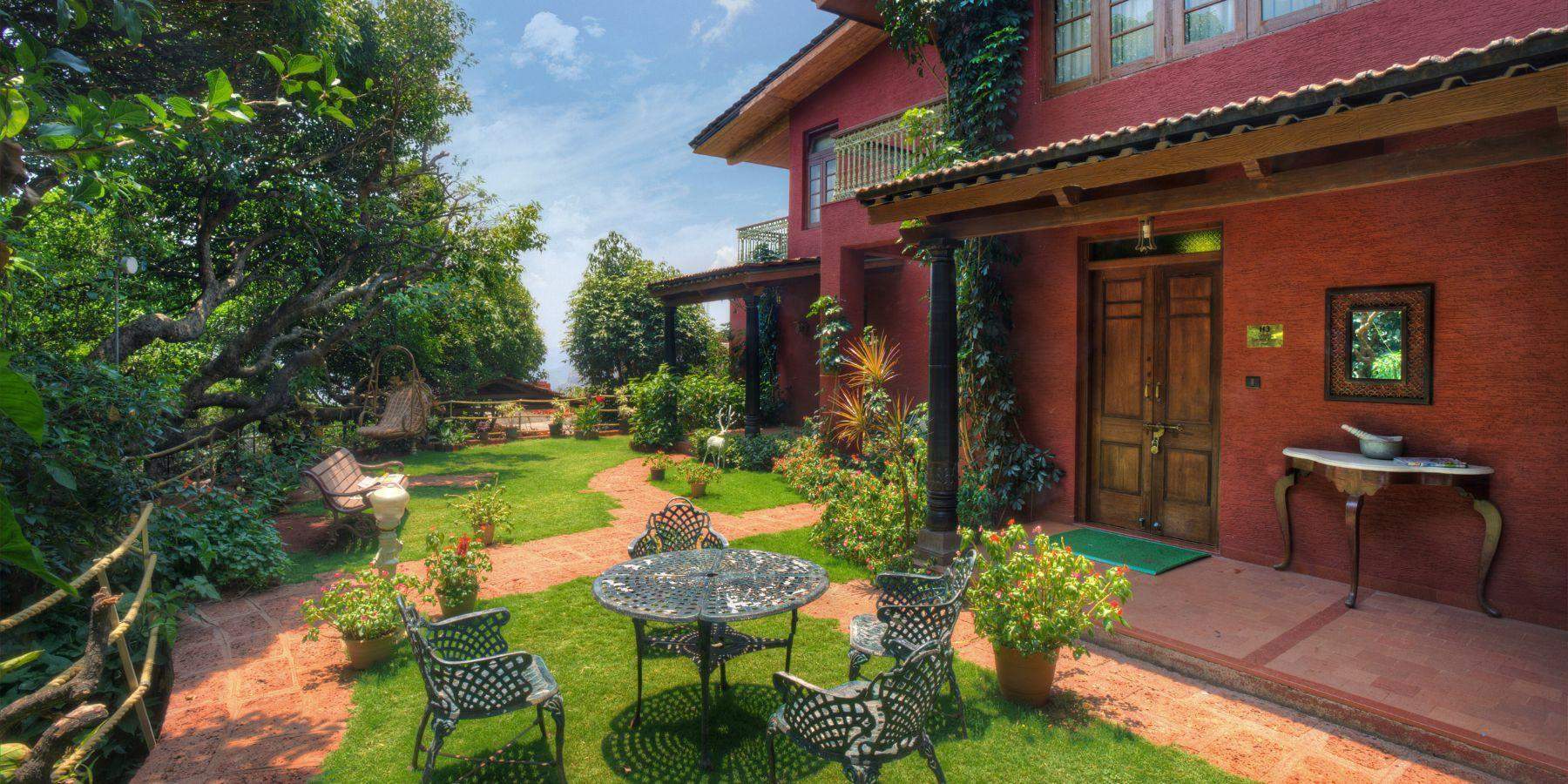 Beautiful garden area with seating arrangements outside Ramsukh Resort in Mahabaleshwar.